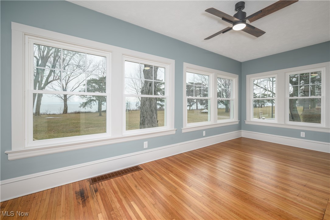 17728 Windward Road Cleveland, OH 44119 - Photo 16 of 32 Unfurnished sunroom with ceiling fan