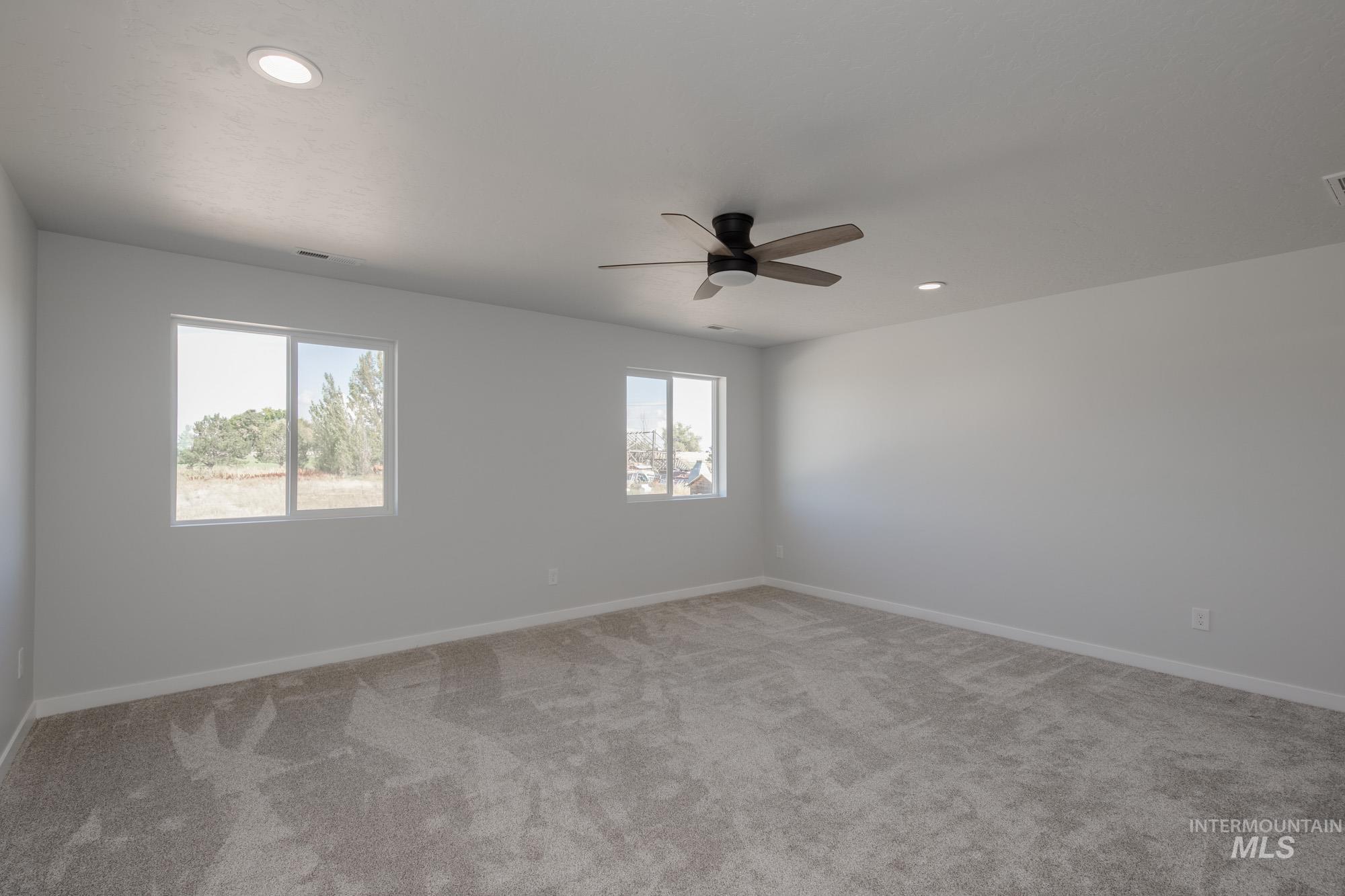3270 West Morere Drive Meridian, ID 83642 - Photo 16 of 26 Spare room with light carpet, recessed lighting, and a ceiling fan