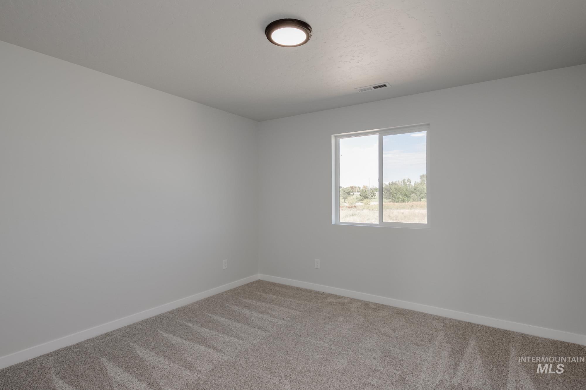 3270 West Morere Drive Meridian, ID 83642 - Photo 21 of 26 Spare room featuring light colored carpet and baseboards
