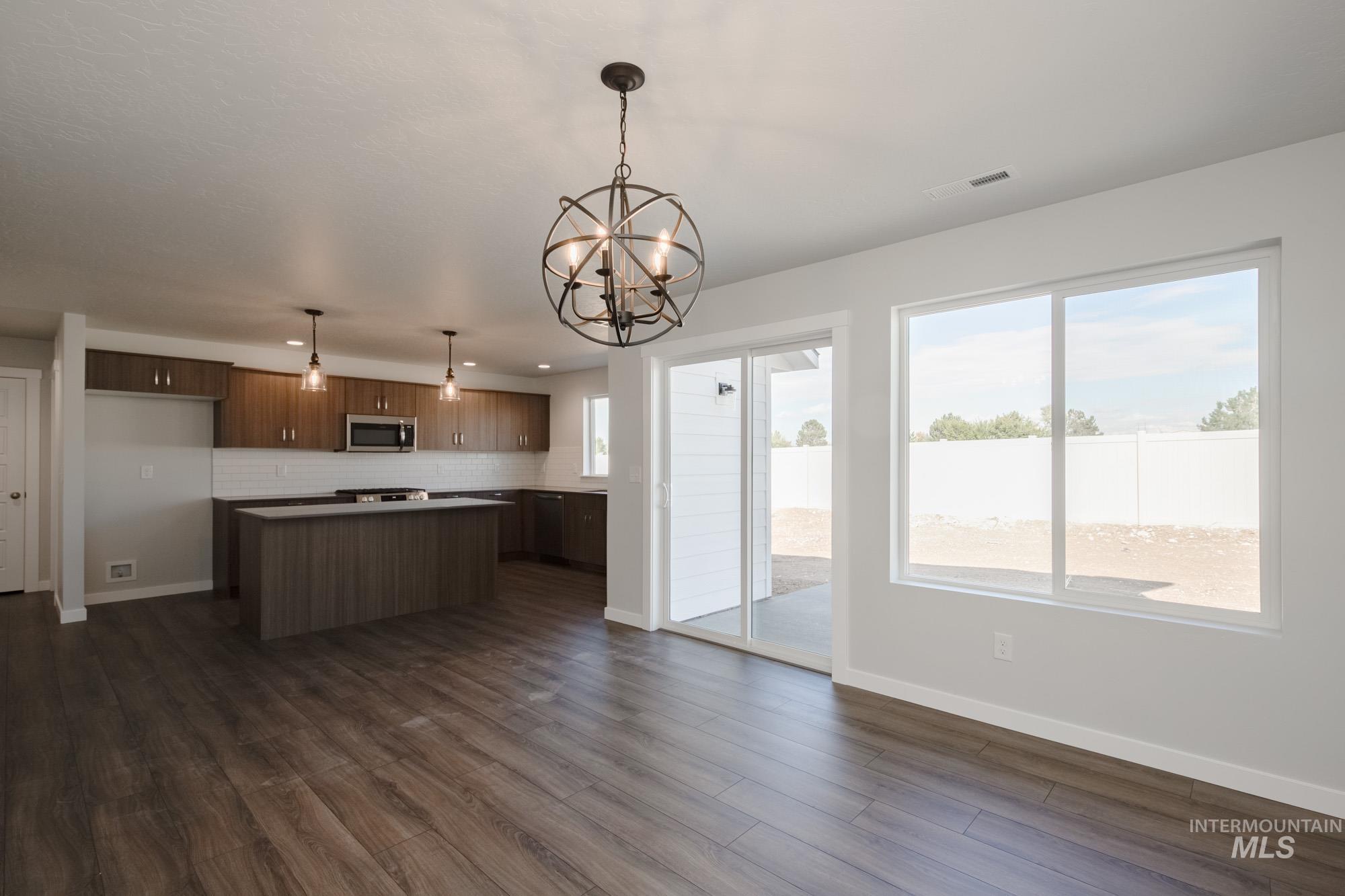 3270 West Morere Drive Meridian, ID 83642 - Photo 26 of 26 Kitchen with pendant lighting, open floor plan, healthy amount of natural light, and a chandelier