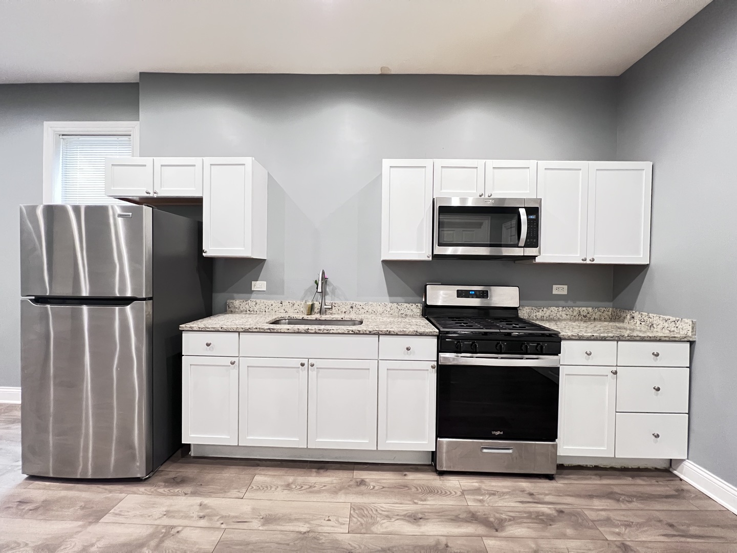 7057 South Normal Boulevard, Unit 2 Chicago, IL 60621 - Photo 11 of 46 a kitchen with stainless steel appliances a stove a sink and a refrigerator