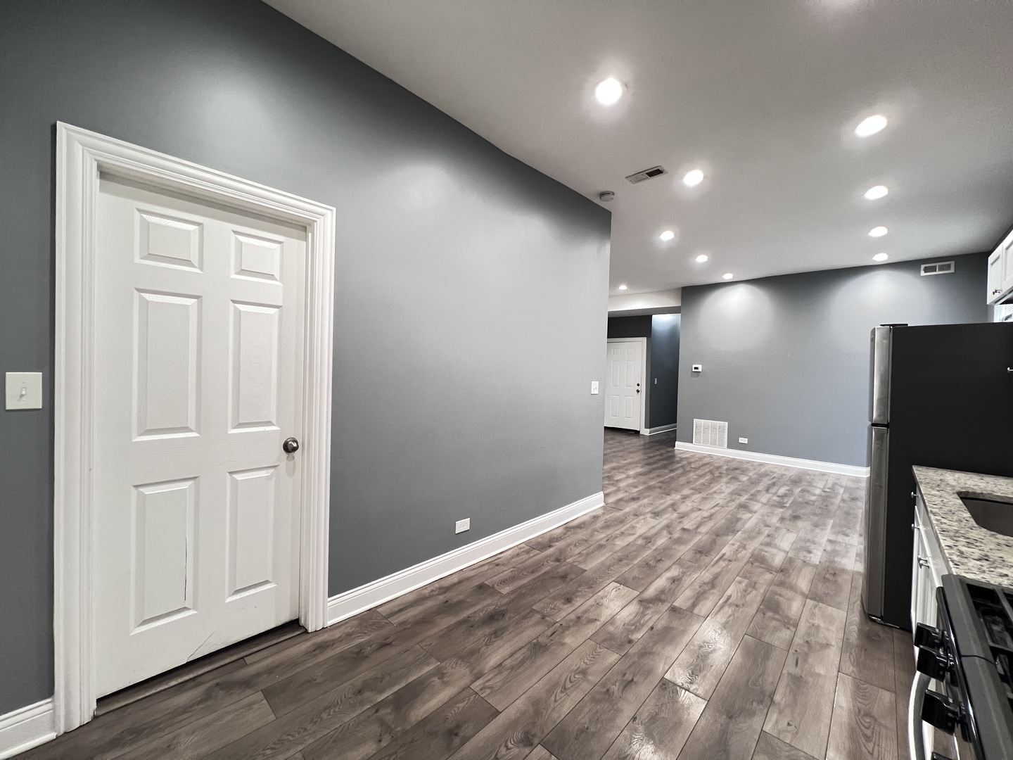 7057 South Normal Boulevard, Unit 2 Chicago, IL 60621 - Photo 13 of 46 a view of a livingroom with a hall and wooden floor