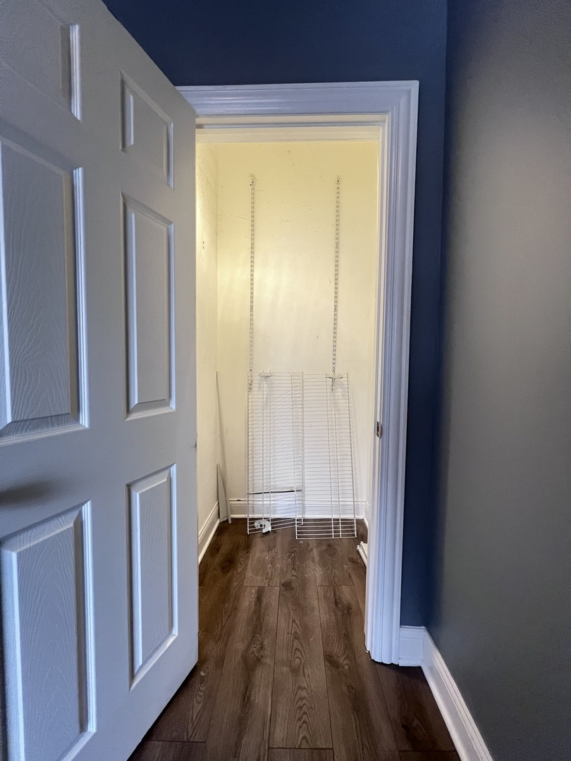 7057 South Normal Boulevard, Unit 2 Chicago, IL 60621 - Photo 19 of 46 a view of a hallway with wooden floor and a window