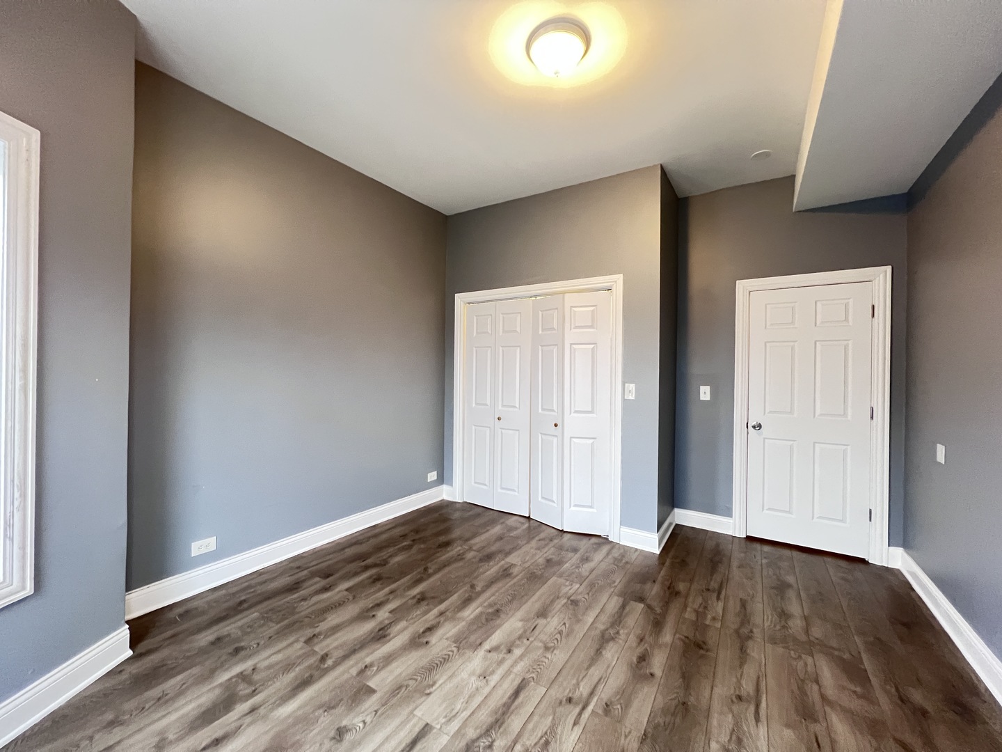 7057 South Normal Boulevard, Unit 2 Chicago, IL 60621 - Photo 22 of 46 a view of wooden floor and windows in a room