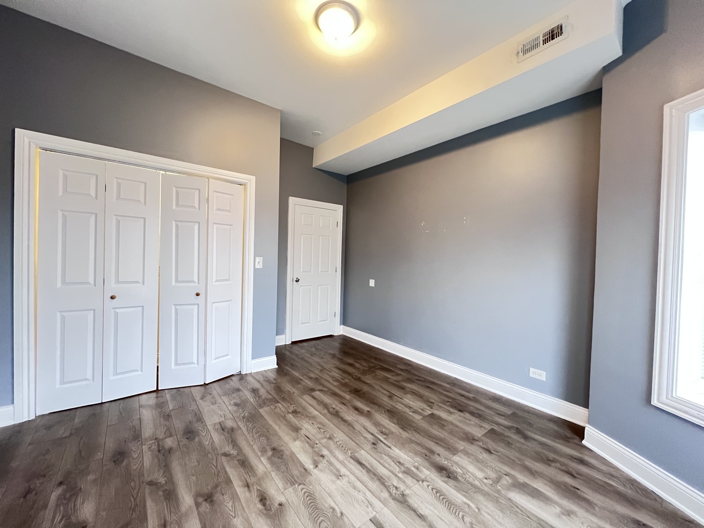 7057 South Normal Boulevard, Unit 2 Chicago, IL 60621 - Photo 23 of 46 a view of an empty room and window