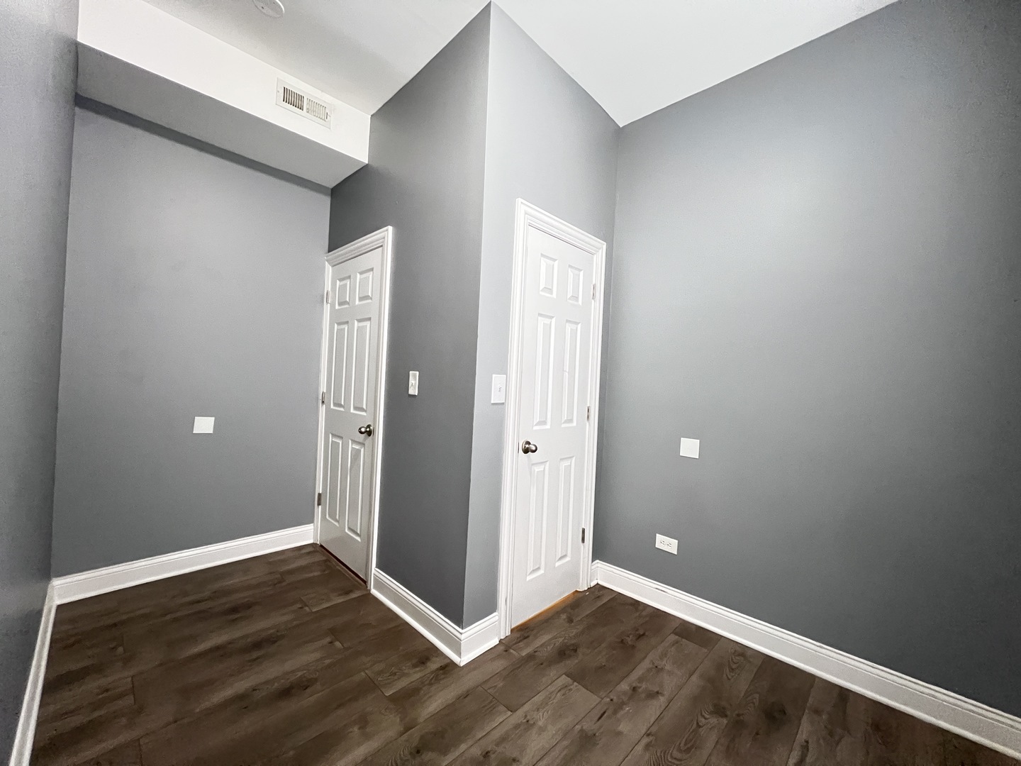 7057 South Normal Boulevard, Unit 2 Chicago, IL 60621 - Photo 29 of 46 a view of an empty room with wooden floor and closet