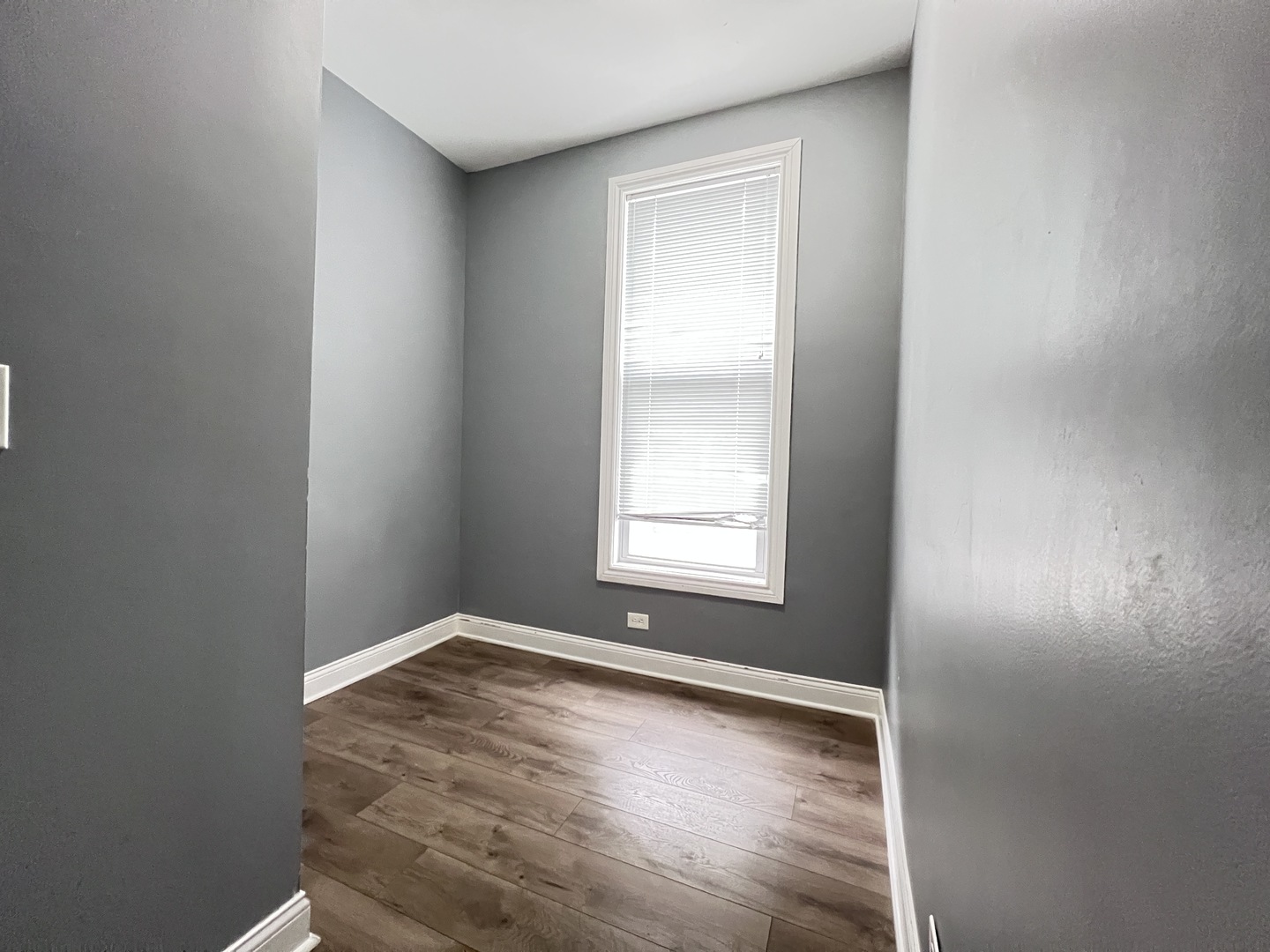 7057 South Normal Boulevard, Unit 2 Chicago, IL 60621 - Photo 31 of 46 an empty room with wooden floor and windows
