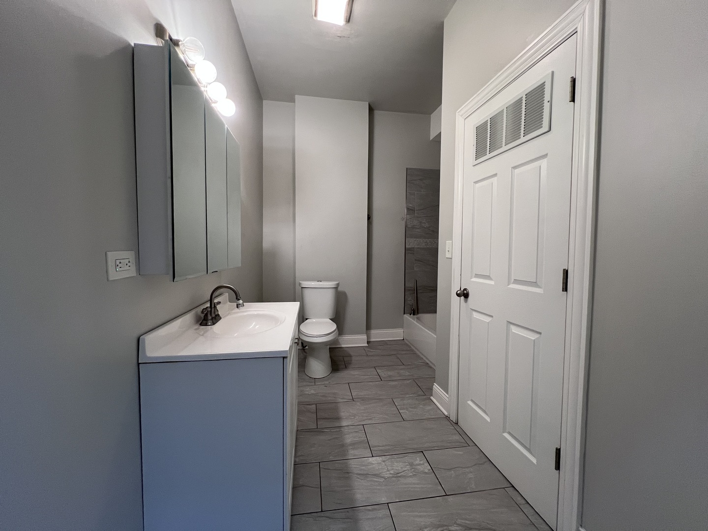 7057 South Normal Boulevard, Unit 2 Chicago, IL 60621 - Photo 32 of 46 a bathroom with a sink and mirror