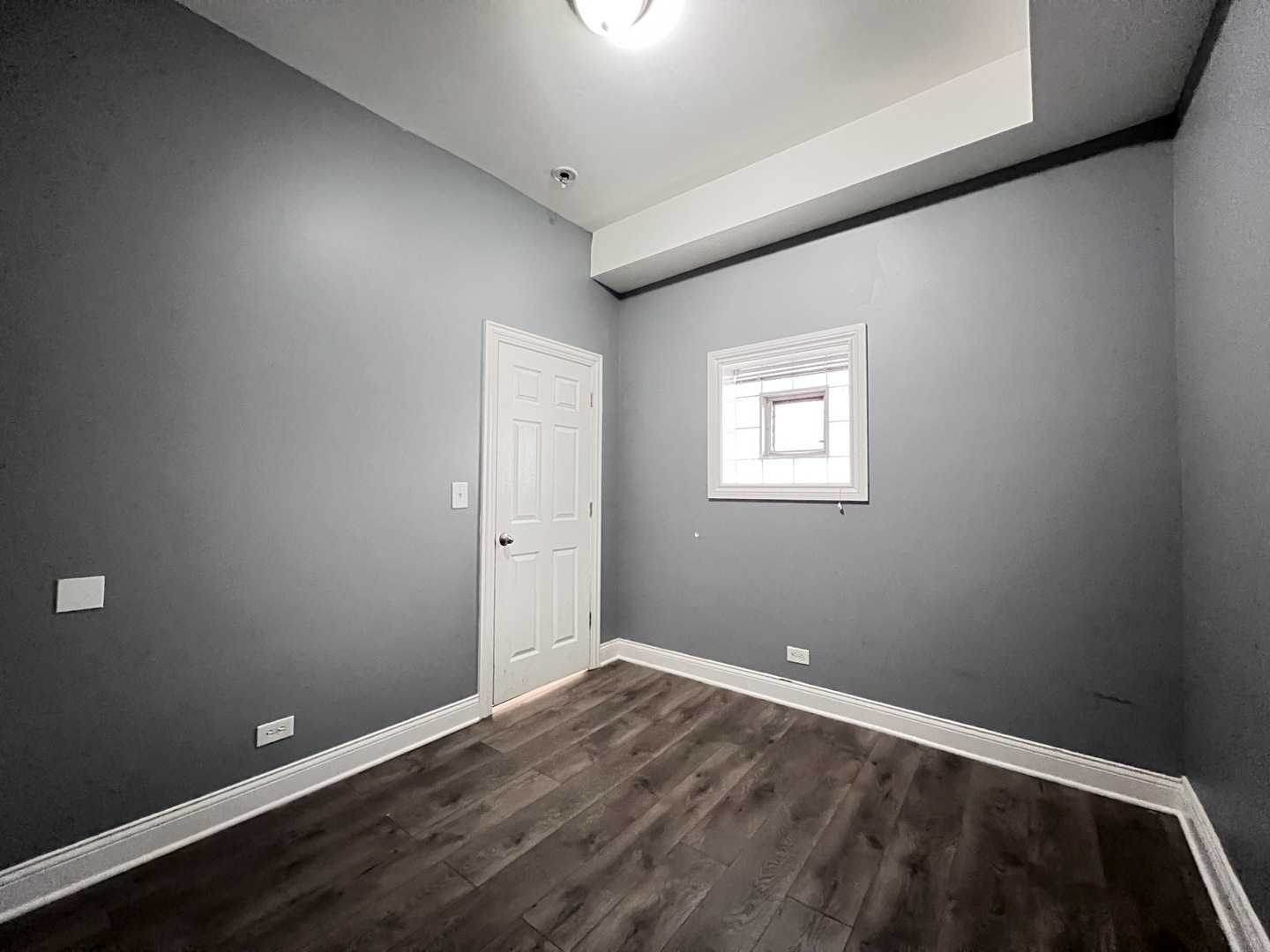 7057 South Normal Boulevard, Unit 2 Chicago, IL 60621 - Photo 38 of 46 an empty room with wooden floor and windows