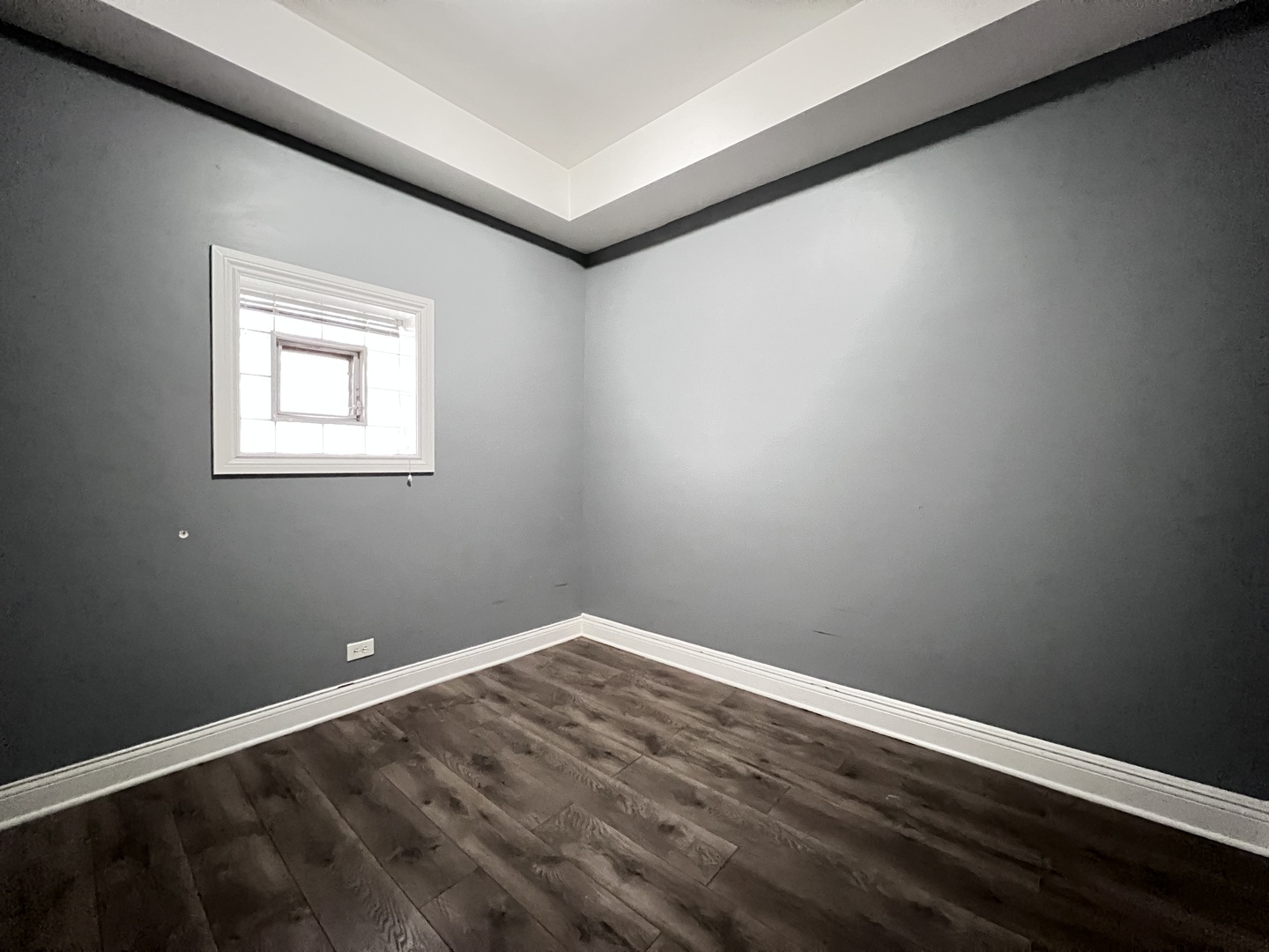 7057 South Normal Boulevard, Unit 2 Chicago, IL 60621 - Photo 39 of 46 a view of an empty room with wooden floor and a window