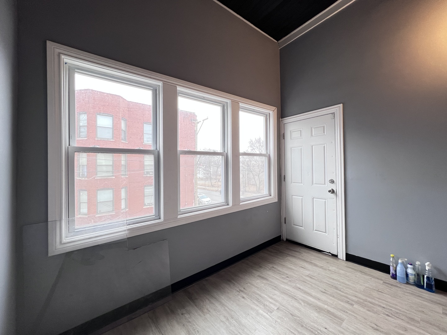 7057 South Normal Boulevard, Unit 2 Chicago, IL 60621 - Photo 42 of 46 an empty room with wooden floor and windows
