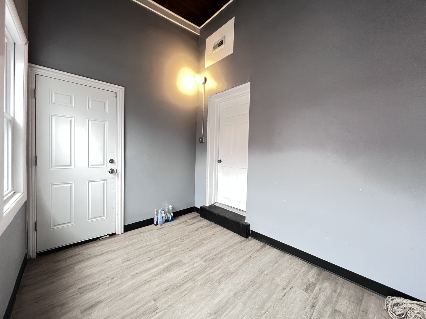 7057 South Normal Boulevard, Unit 2 Chicago, IL 60621 - Photo 43 of 46 an empty room with wooden floor and windows