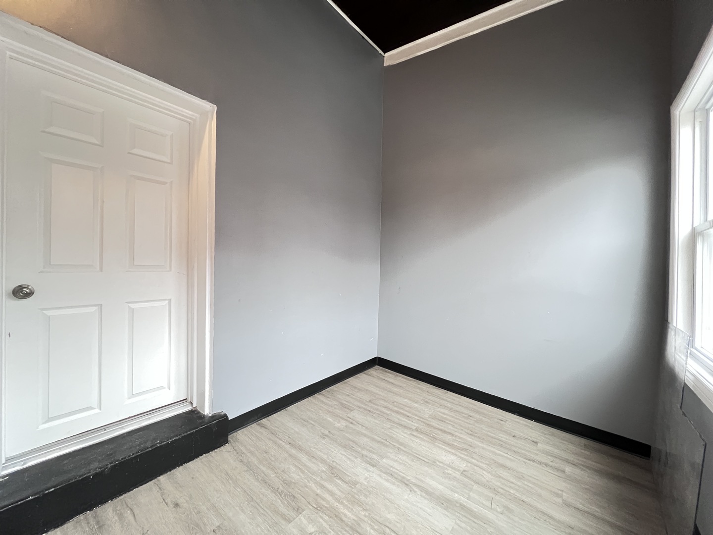 7057 South Normal Boulevard, Unit 2 Chicago, IL 60621 - Photo 44 of 46 an empty room with wooden floor and windows