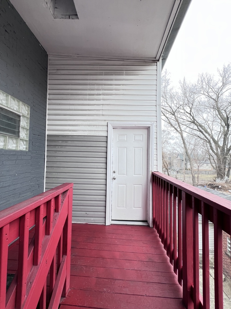 7057 South Normal Boulevard, Unit 2 Chicago, IL 60621 - Photo 45 of 46 a view of a house with wooden deck