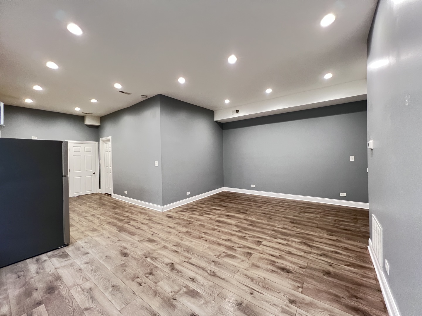 7057 South Normal Boulevard, Unit 2 Chicago, IL 60621 - Photo 7 of 46 a view of an empty room with wooden floor