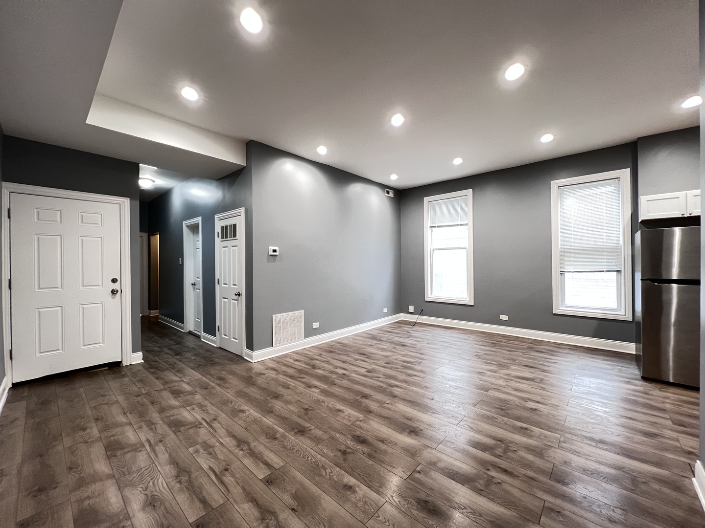 7057 South Normal Boulevard, Unit 2 Chicago, IL 60621 - Photo 8 of 46 a view of empty room with wooden floor
