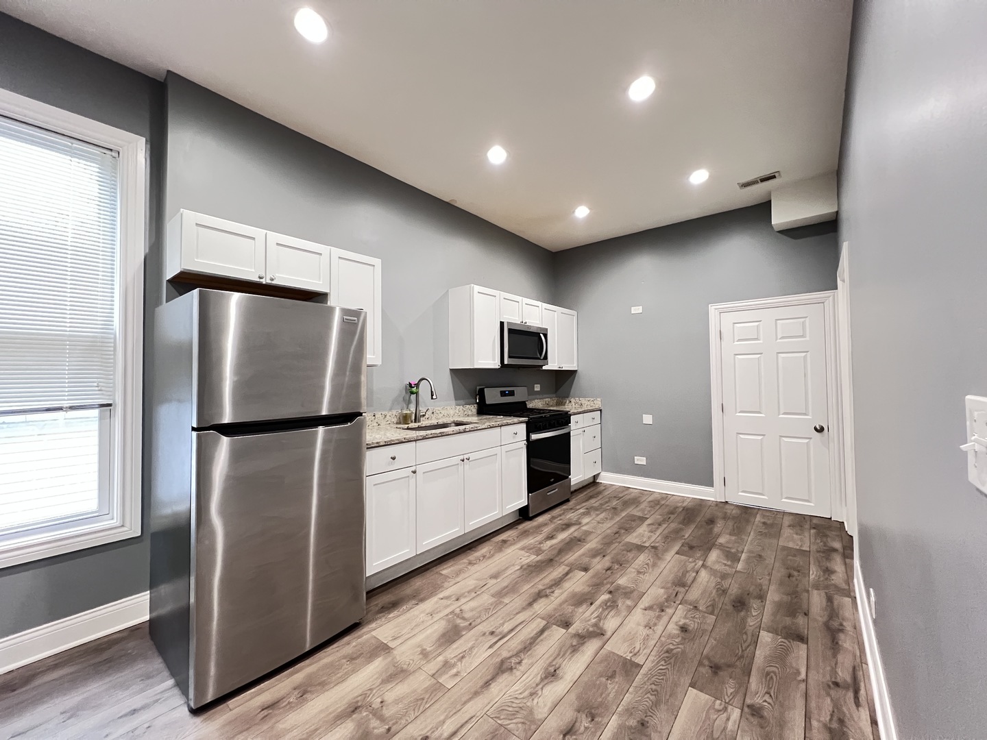 7057 South Normal Boulevard, Unit 2 Chicago, IL 60621 - Photo 10 of 46 a kitchen with refrigerator and microwave