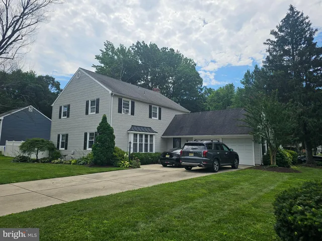 a car parked in front of white house
