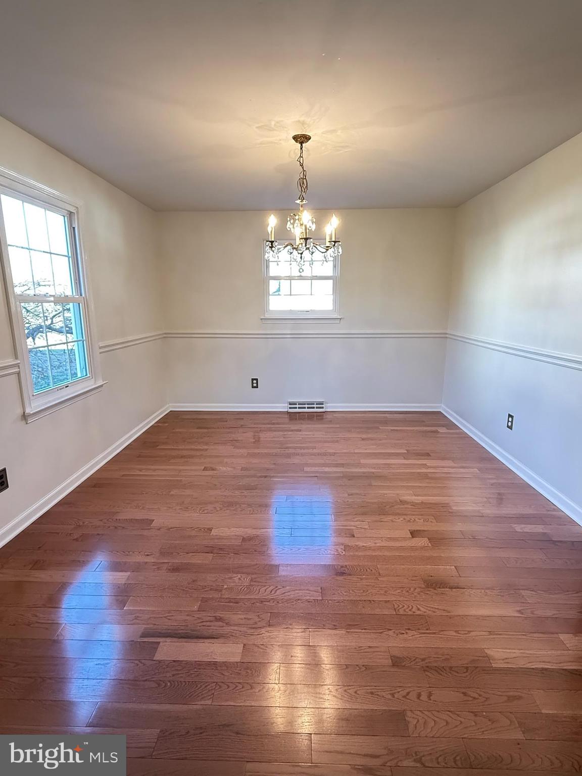 142 Fox Chase Drive Delran, NJ 08075 - Photo 13 of 26 an empty room with wooden floor chandelier and windows