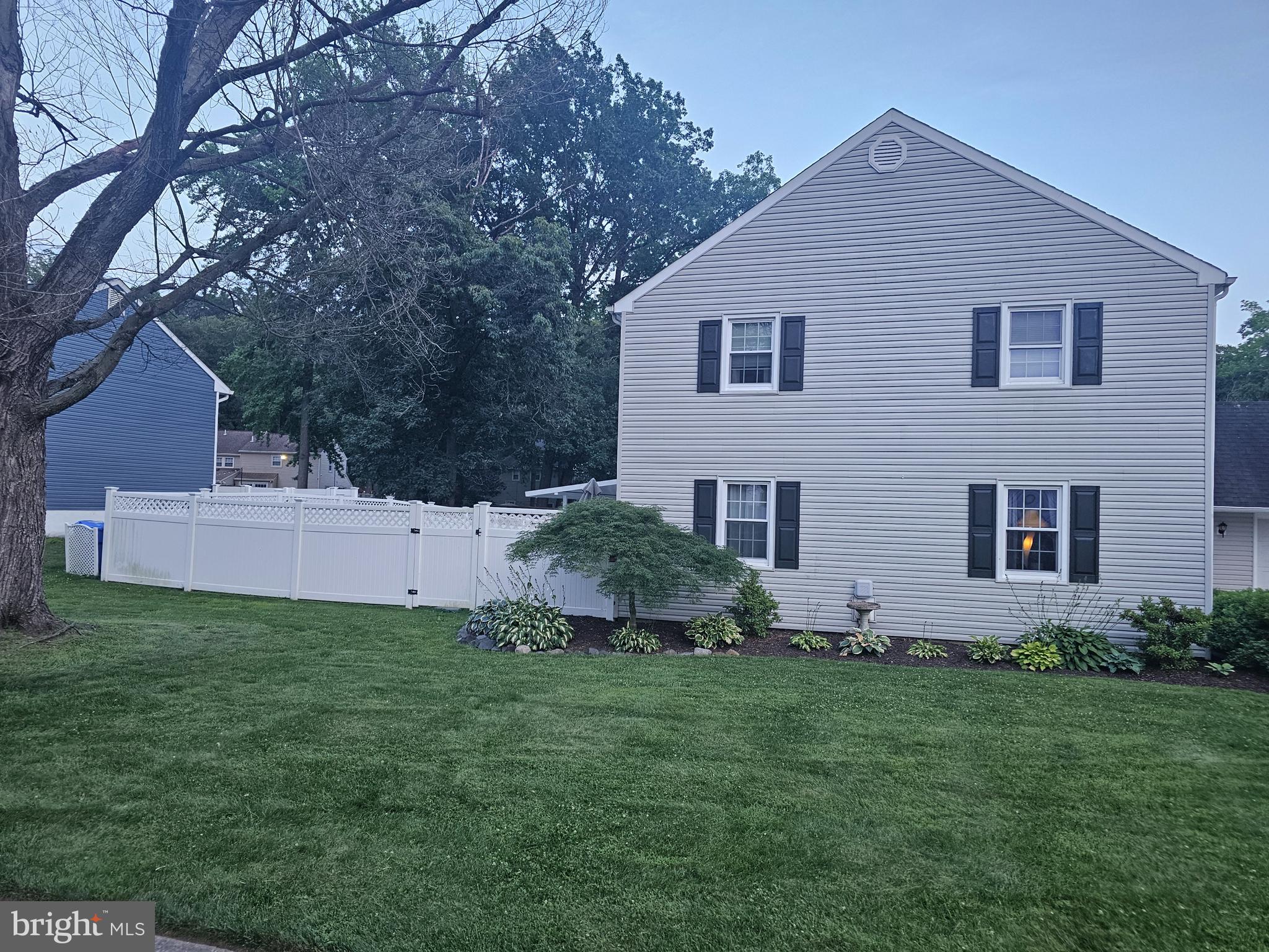 142 Fox Chase Drive Delran, NJ 08075 - Photo 2 of 26 a front view of a house with a garden and yard