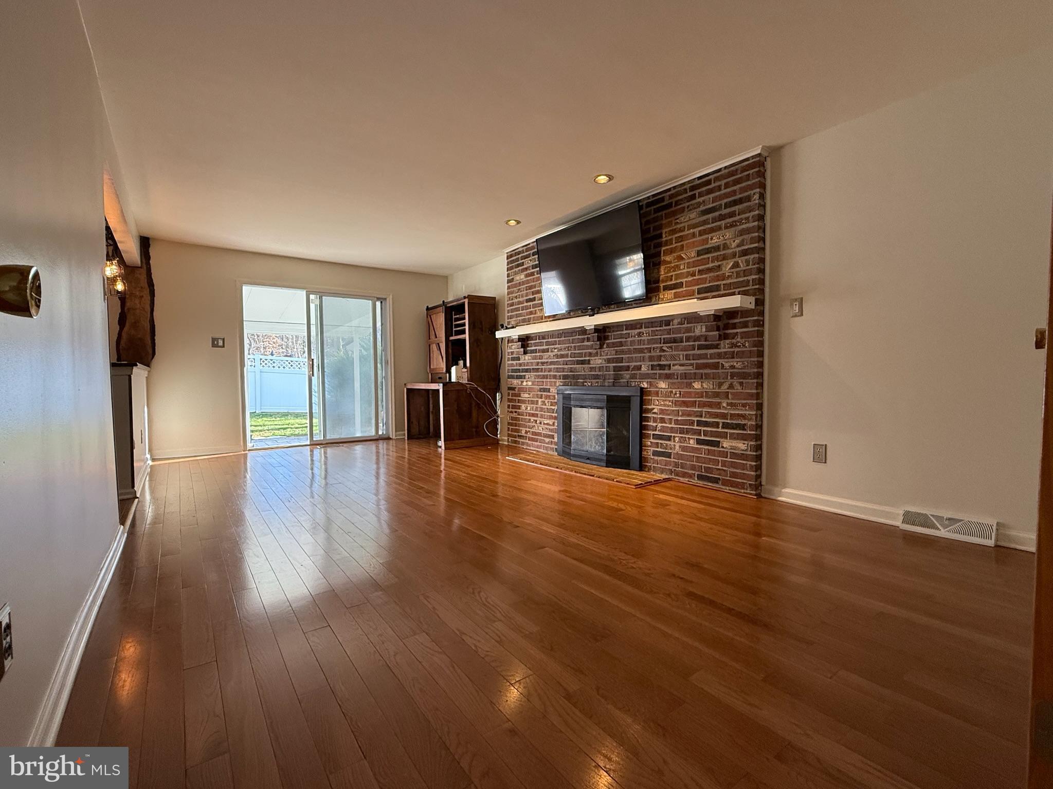 142 Fox Chase Drive Delran, NJ 08075 - Photo 7 of 26 wooden floor in an empty room with a fireplace