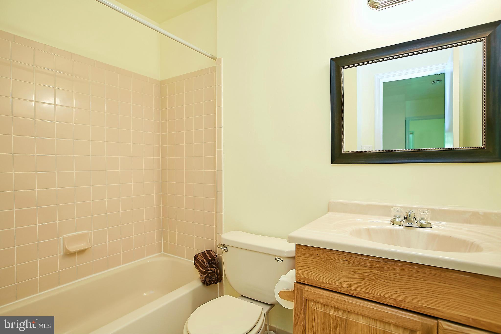 8567 Tyrolean Way Springfield, VA 22153 - Photo 21 of 29 a bathroom with a sink a toilet and shower