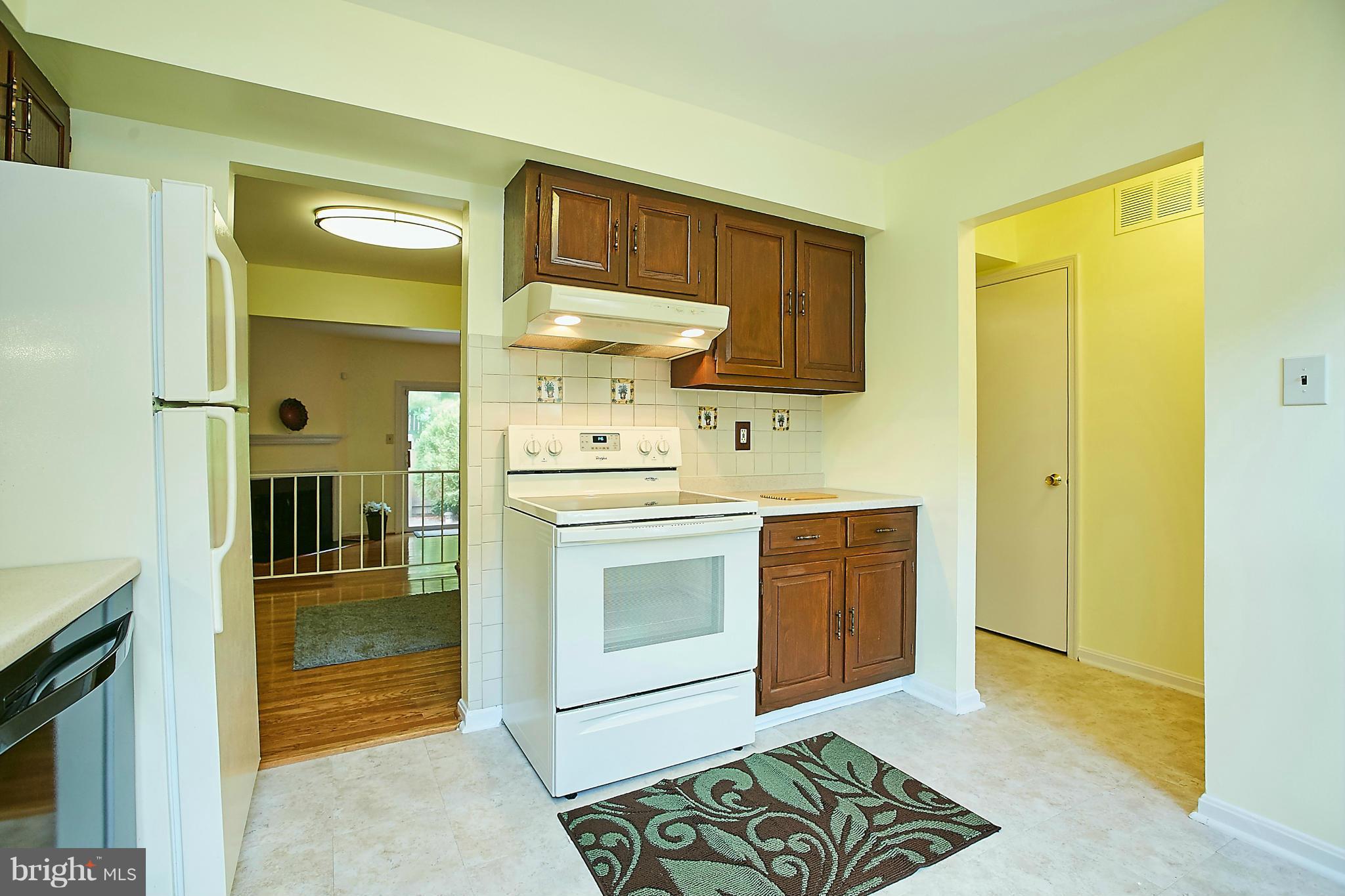 8567 Tyrolean Way Springfield, VA 22153 - Photo 6 of 29 a kitchen with stainless steel appliances granite countertop a stove a sink and a refrigerator