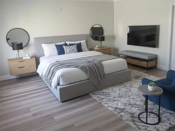 a bedroom with bed and a flat screen tv