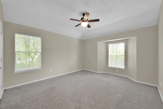 a view of n empty room with a window