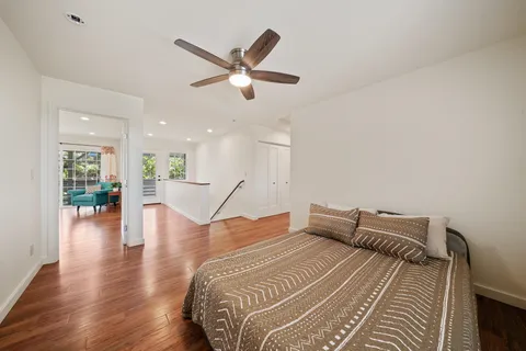 a bedroom with a bed and wooden floor