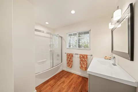 a bedroom with a bed and wooden floor