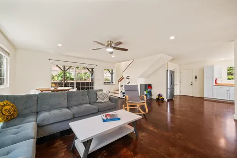 a living room with furniture and wooden floor