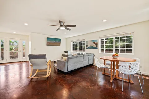 a bathroom with a toilet sink double vanity and mirror