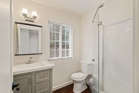 a bed sitting in a bedroom next to a window