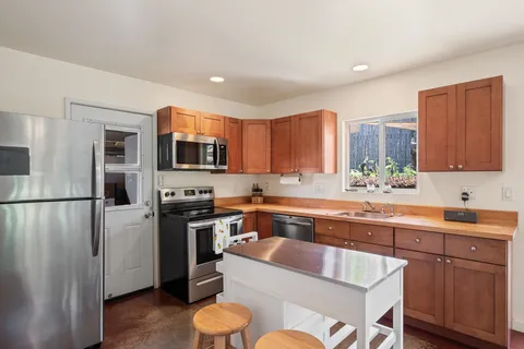 a bedroom with a large bed and a large window with wooden floor