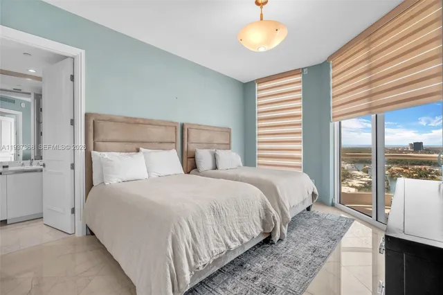 a bedroom with a balcony a bed and a chandelier