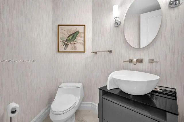 a bathroom with a toilet a sink and mirror