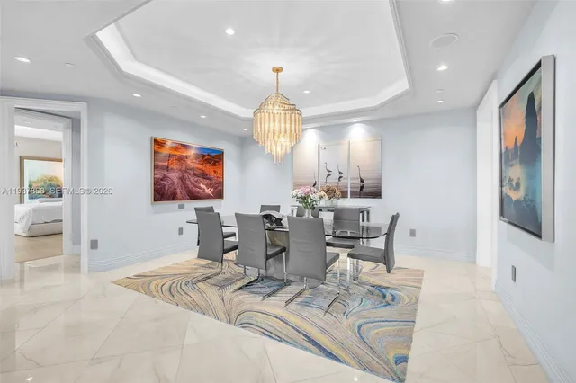 a living room with furniture a chandelier and a flat screen tv