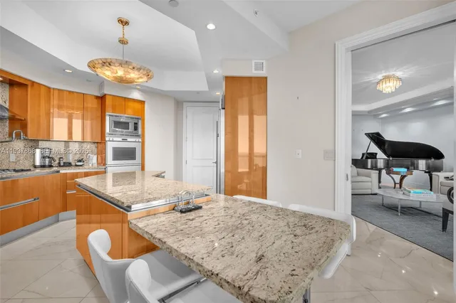 a kitchen with granite countertop sink and stove