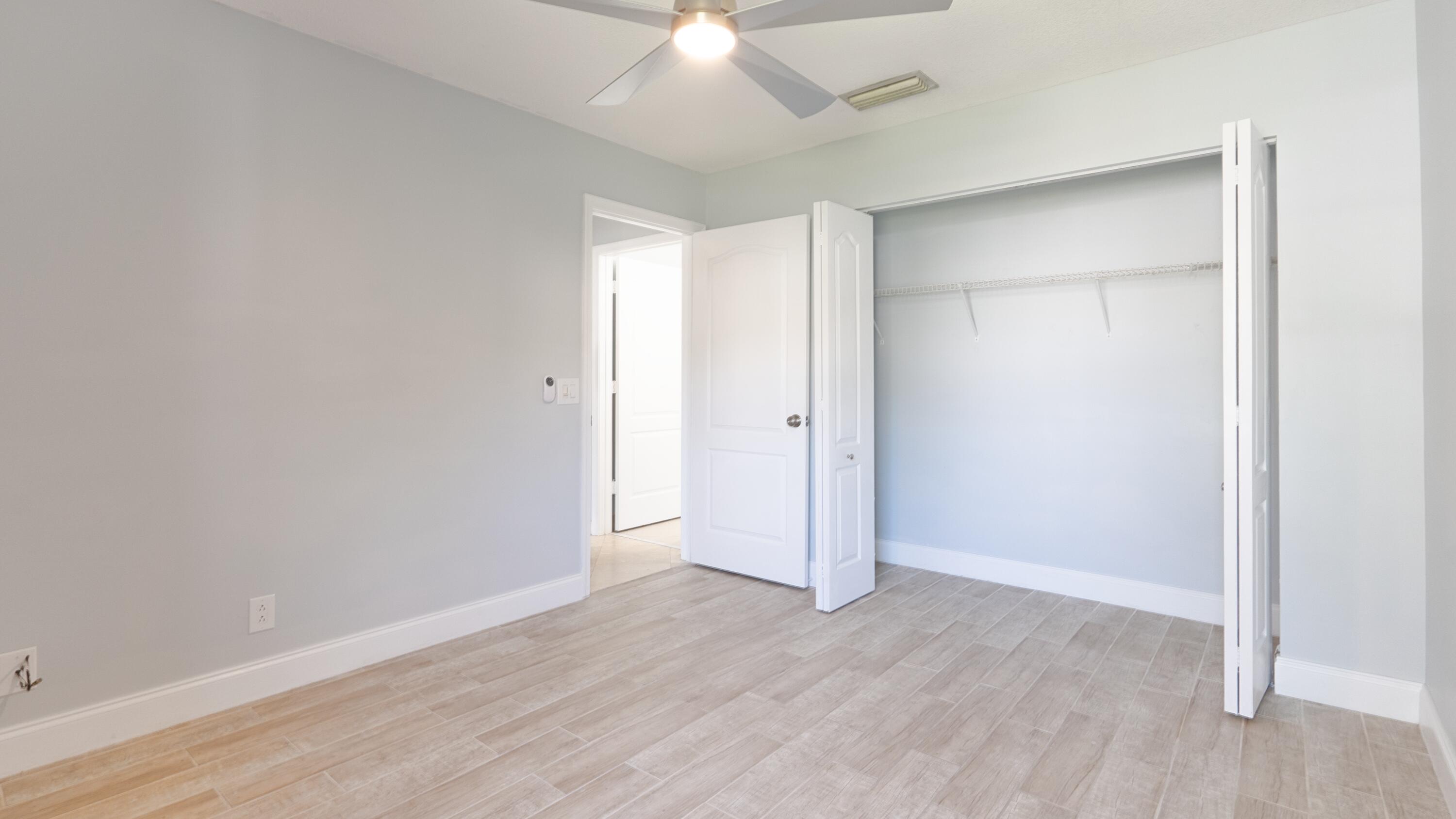 10789 Barque Court Boca Raton, FL 33498 - Photo 19 of 31 a view of an empty room with wooden floor