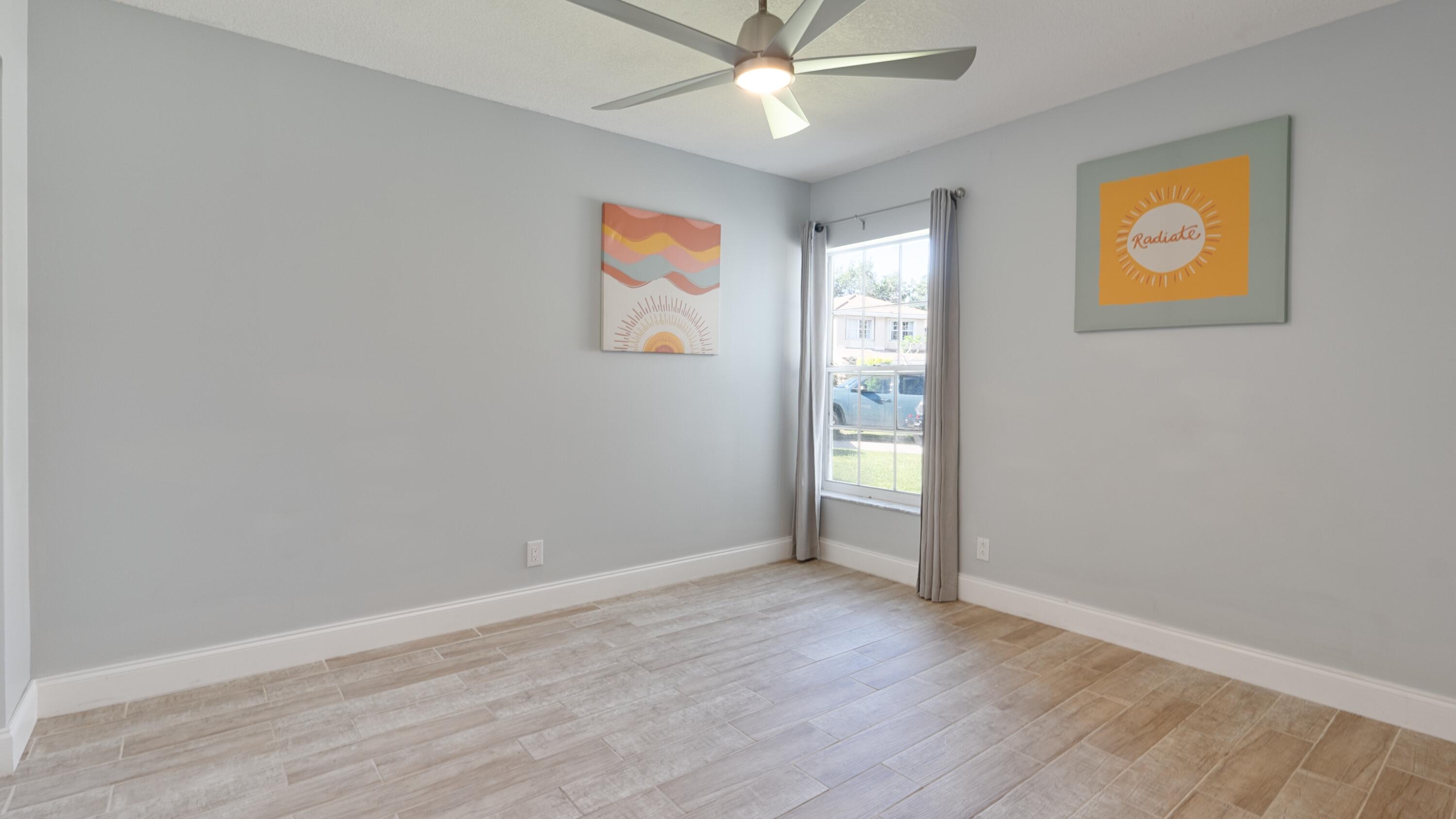 10789 Barque Court Boca Raton, FL 33498 - Photo 20 of 31 an empty room with window and ceiling fan