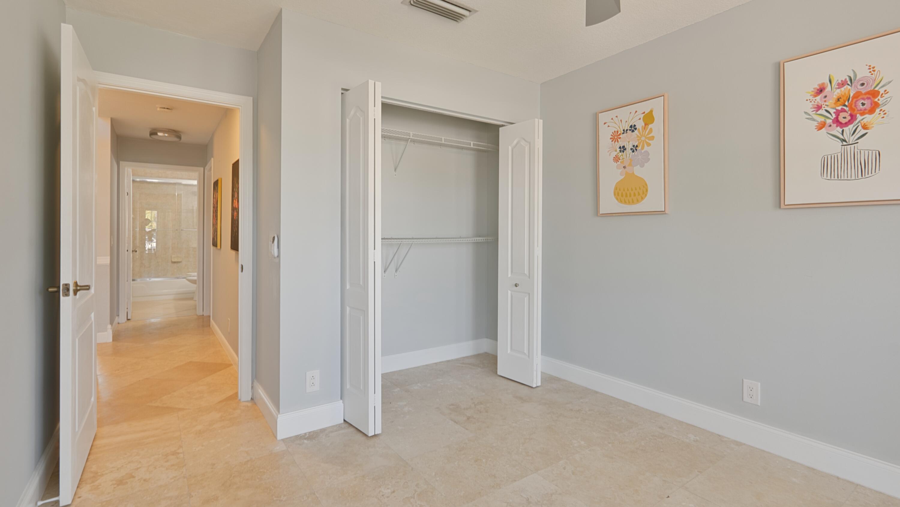 10789 Barque Court Boca Raton, FL 33498 - Photo 22 of 31 a view of a hallway with paintings on the wall