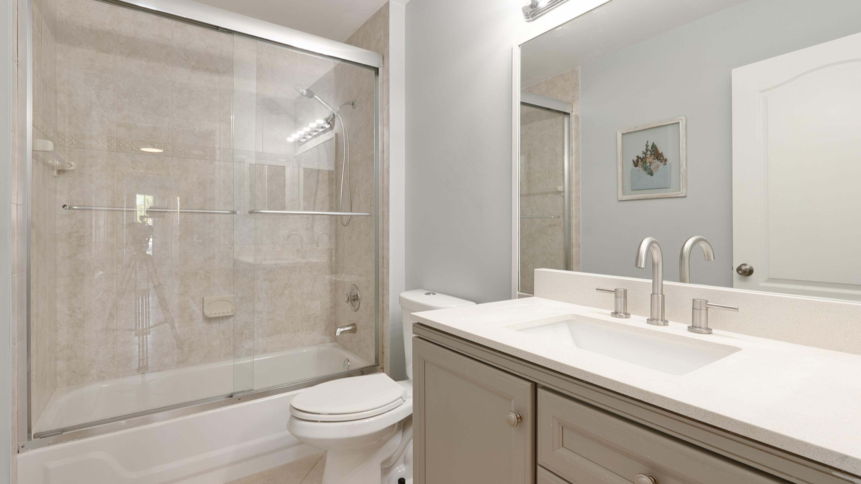 10789 Barque Court Boca Raton, FL 33498 - Photo 24 of 31 a bathroom with a sink a toilet and shower