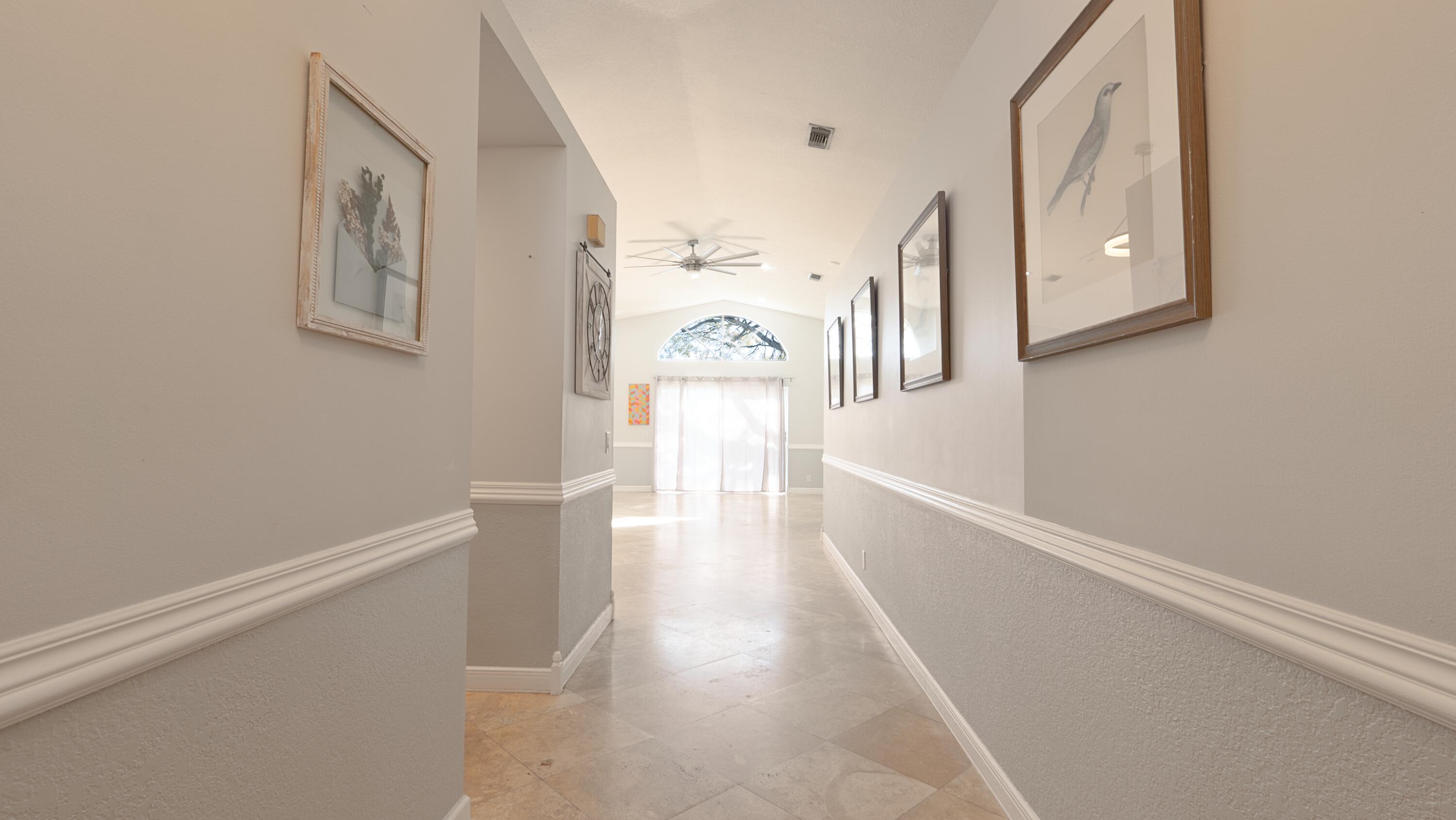 10789 Barque Court Boca Raton, FL 33498 - Photo 3 of 31 a view of a hallway view with wooden floor and staircase