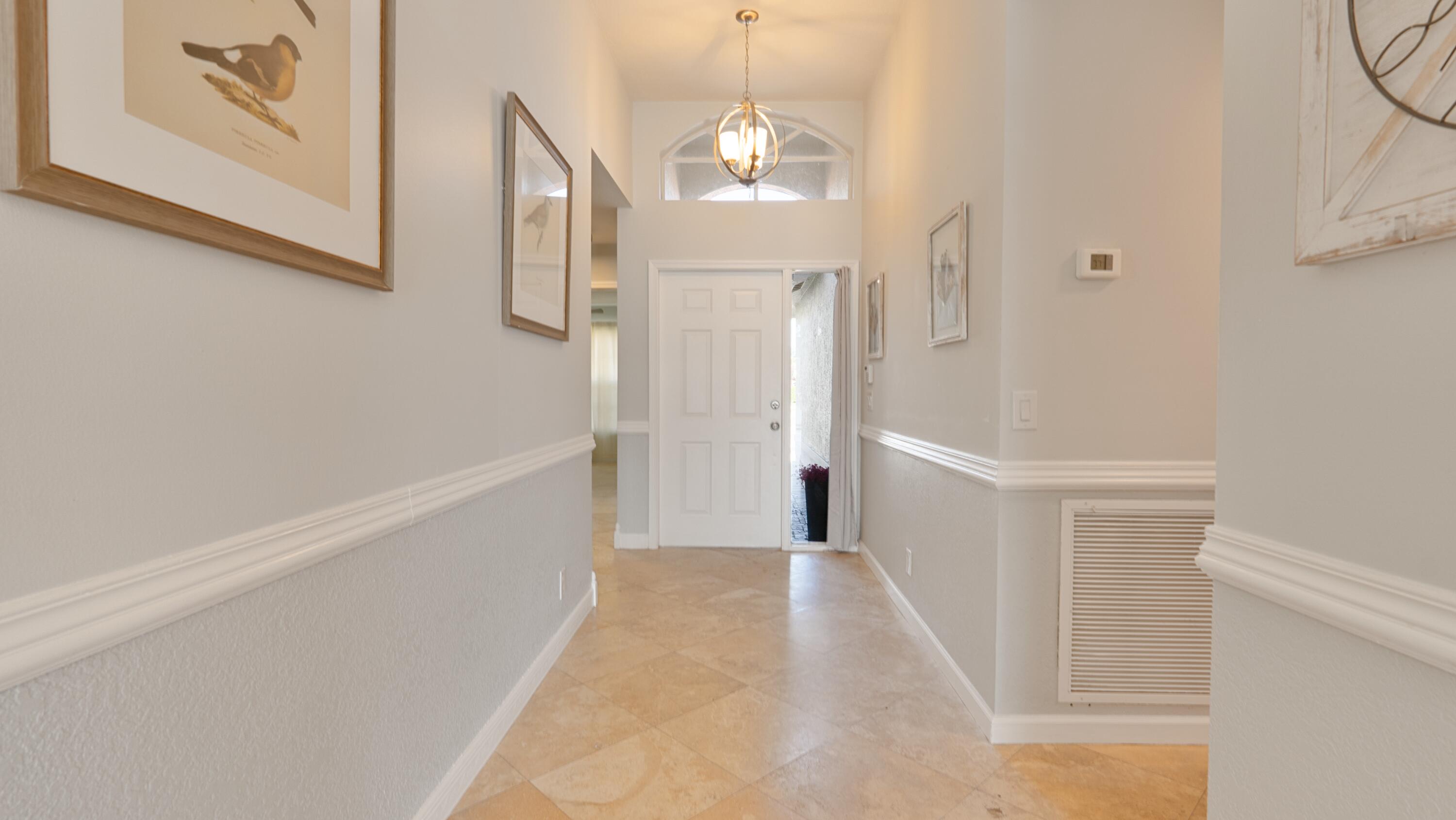 10789 Barque Court Boca Raton, FL 33498 - Photo 4 of 31 a view of a hallway with wooden floor and staircase
