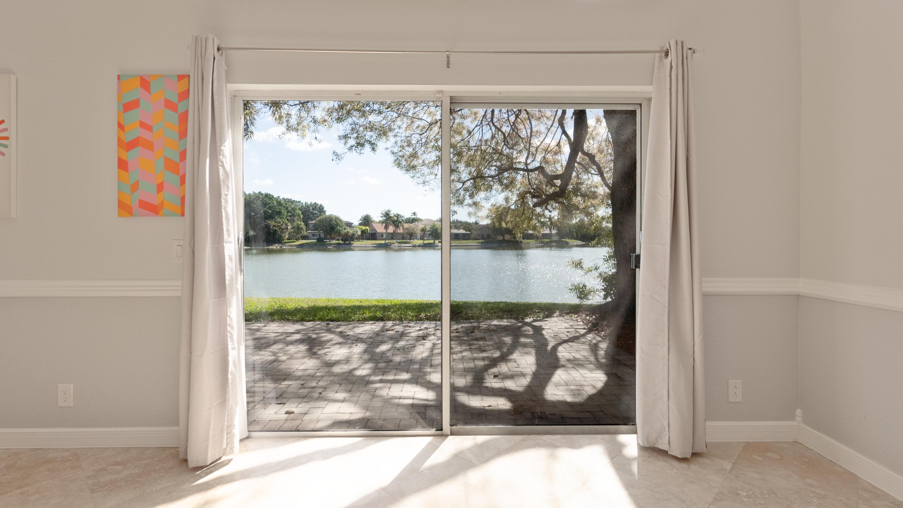 10789 Barque Court Boca Raton, FL 33498 - Photo 8 of 31 a view of a porch with a floor to ceiling window