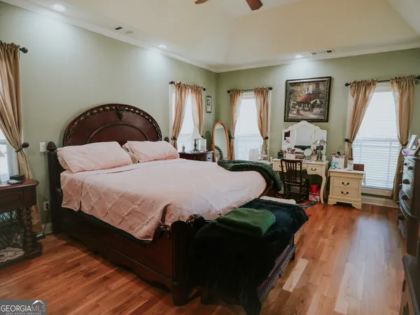 a spacious bedroom with a bed a table and a large window