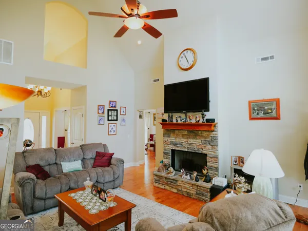 a living room with furniture a flat screen tv and a fireplace