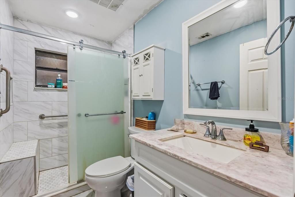 418 Glenn Road Orlando, FL 32833 - Photo 11 of 27 a bathroom with a granite countertop sink mirror toilet and shower