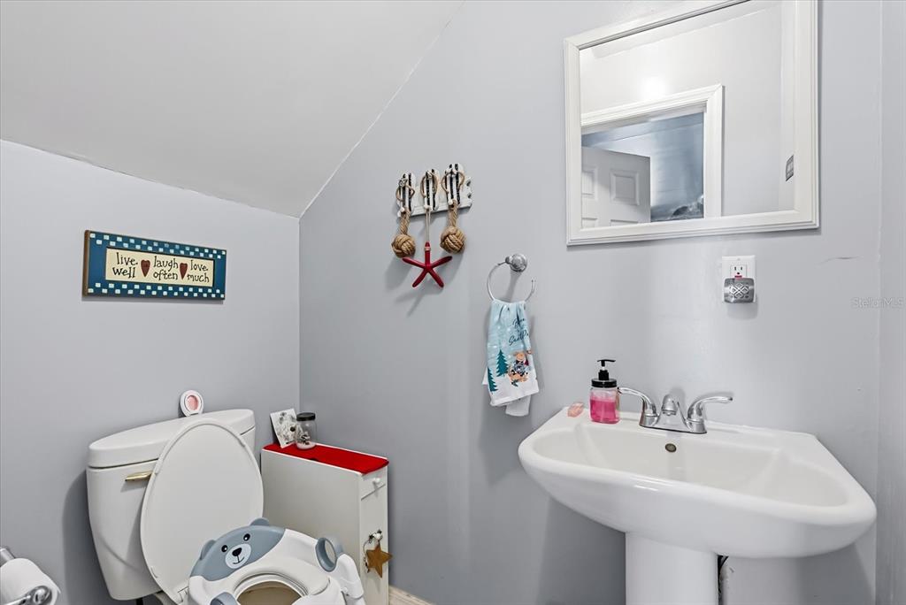 418 Glenn Road Orlando, FL 32833 - Photo 13 of 27 a bathroom with a sink mirror and toilet